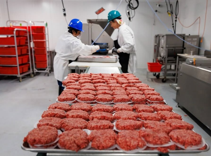 A butcher breaking down beef at the Home Place Pastures processing facility